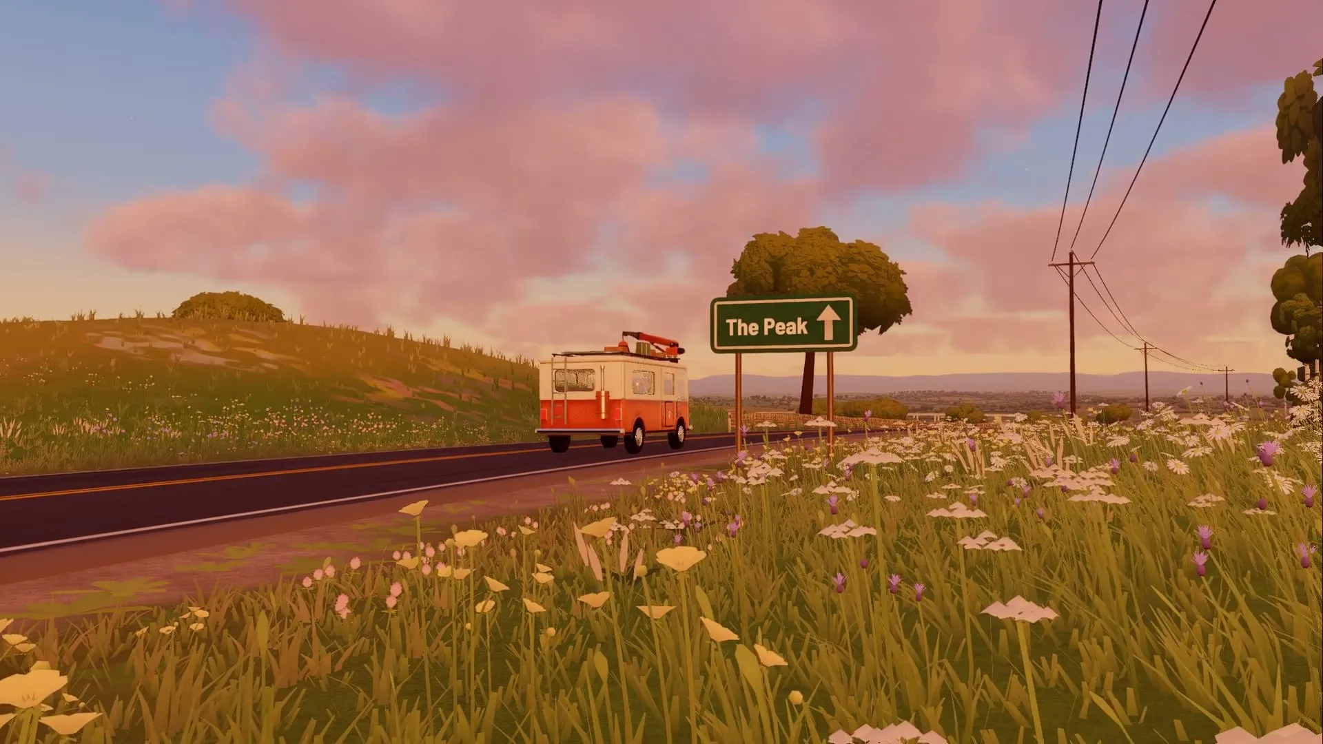 Neil's camper van on a country road at golden hour, a sign for the Peak beside it